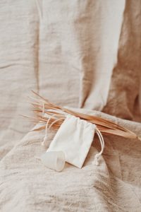 Photo of a Menstrual Cup Beside a White Pouch